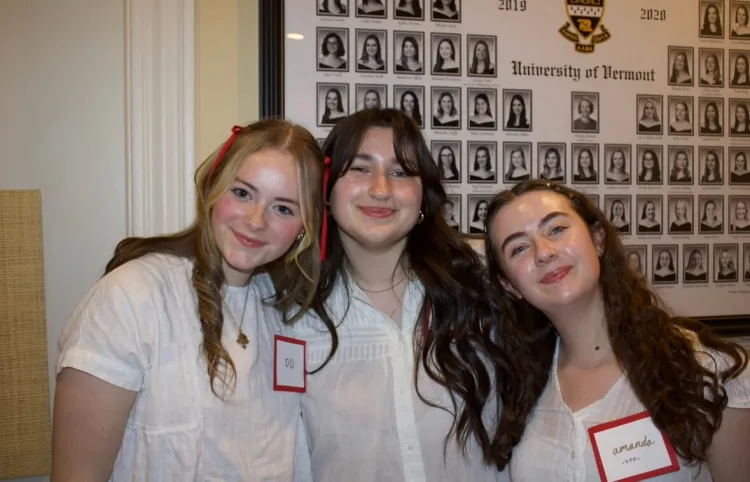 Three women pose at a philanthropy event