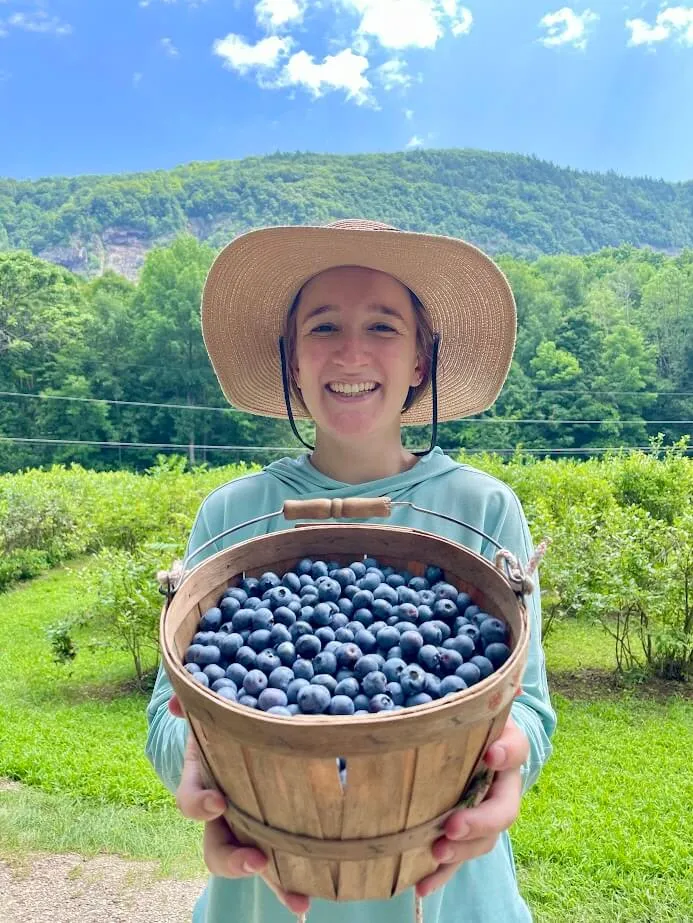 Leslie Spencer holding harvested blueberries