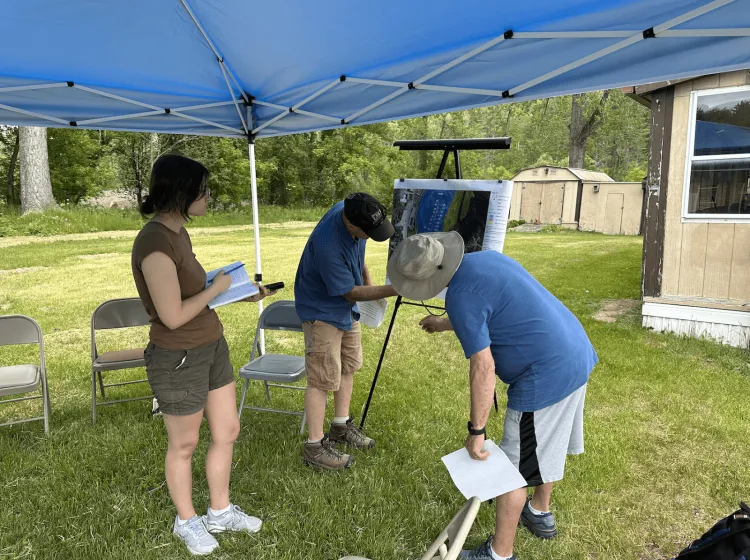 Miranda Degreenia examines flood map at a local mobile home park during a community meeting. (2023)  
