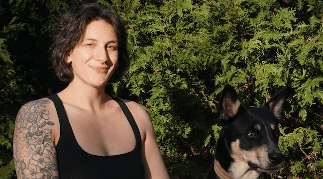 young person sitting with dog