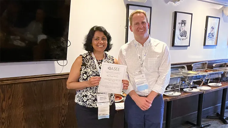 Dr. Priyantha Wijesinghe accepts the award for the ASEE best paper in the Mechanics Division