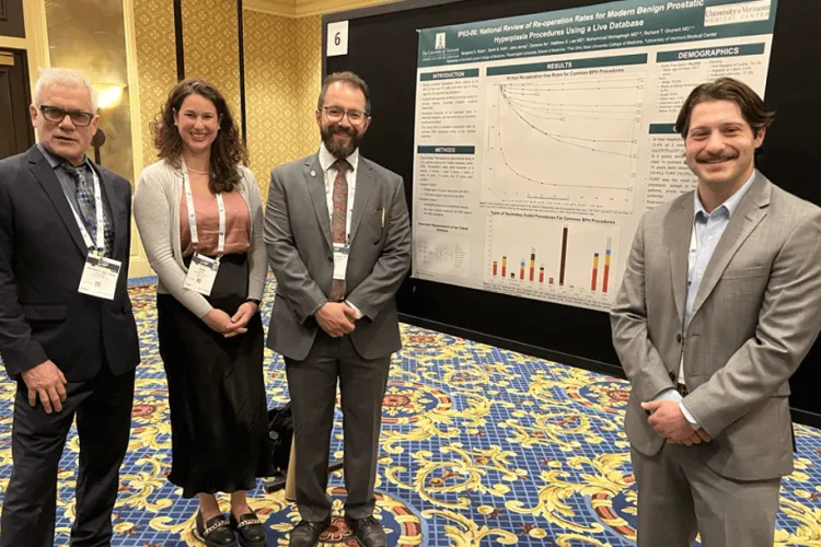 a group of people by a poster at a conference