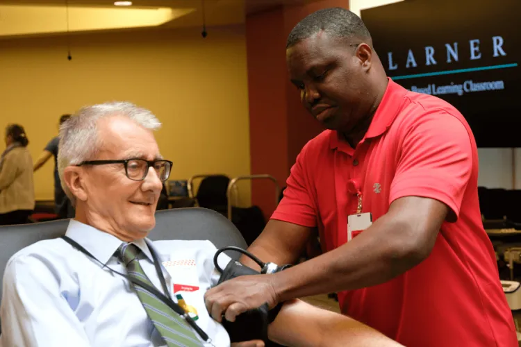 a man drawing blood from another man