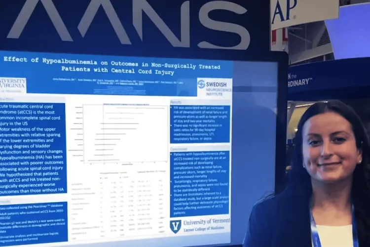 a woman with a poster presentation at a conference