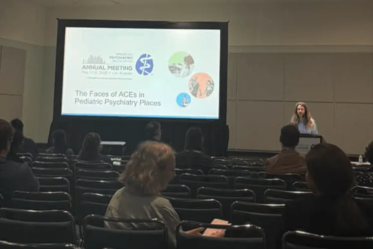 a man presenting at a conference