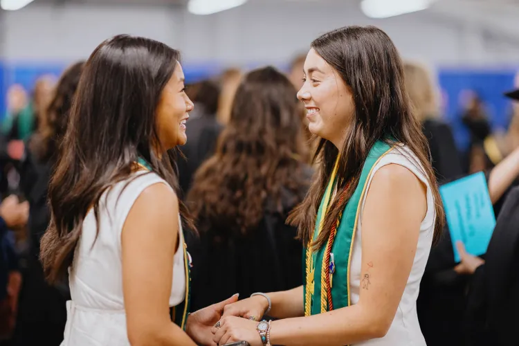 Dexter and a friend holding hands before commencement.