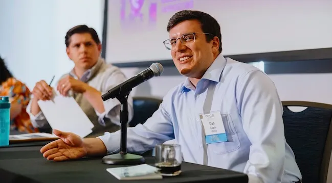 a person speaking at a panle discussion