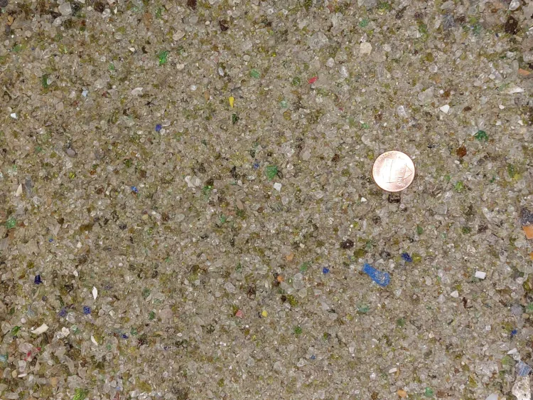 Small pieces of glass with a penny for scale.