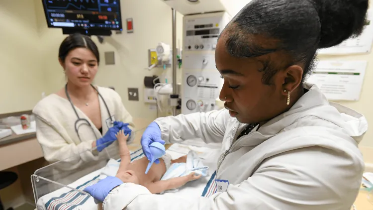 2 women practicing intubation on a manikin