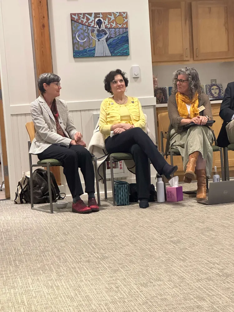 Langevin Prelock Feldman-Hunt sitting together at a meeting