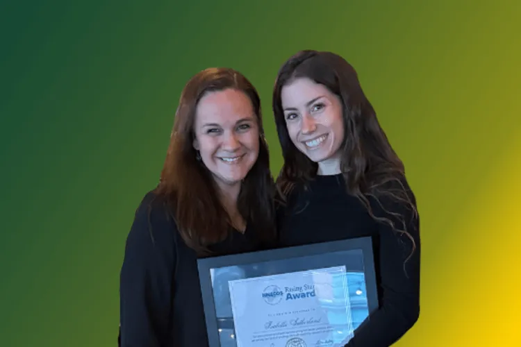 2 women posing with an award certificate