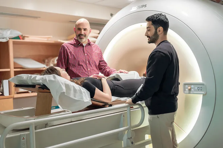 3 people near an MRI machine