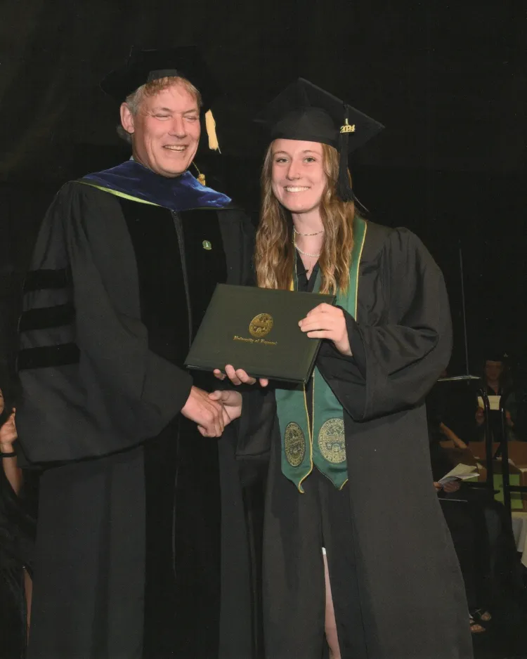 Cat Mawn and Allan Strong shaking hands at Cat's graduation.