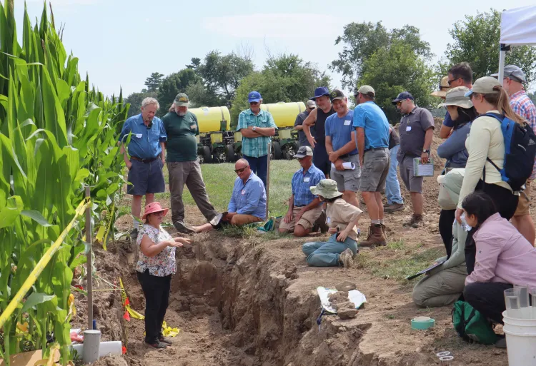 Odette Menard giving a presentation on soil compaction.
