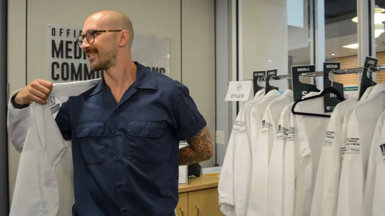 a new medical student trying on a white coat
