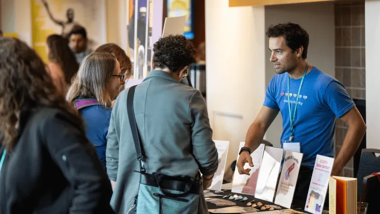 people at a table with a display of books