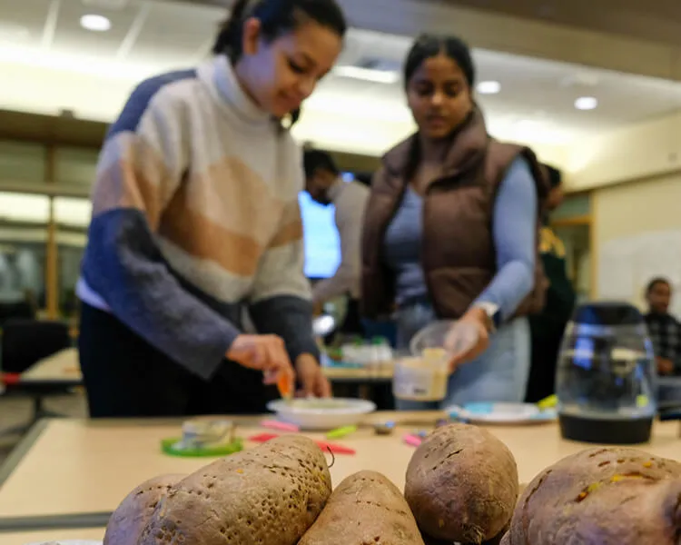 two people cooking with fresh produce