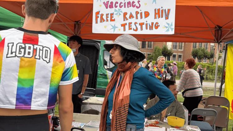 Devika Singh, M.D., associate professor of medicine (center, wearing hat), talked with Burlington Pride festival goers