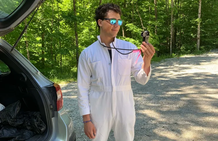Ramsey in safety gear looking at a compass.