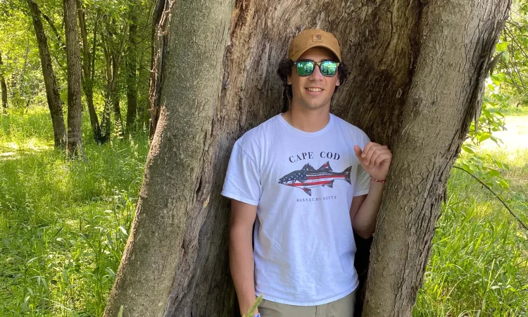 Ramsey standing in the bough of a tree.
