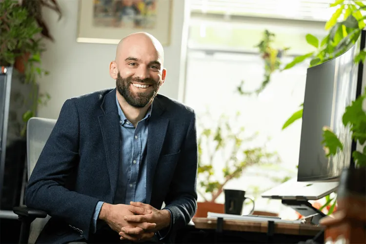 a person smiling in an office