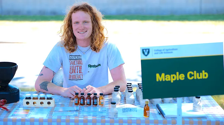 Man seated at a table with maple syrup