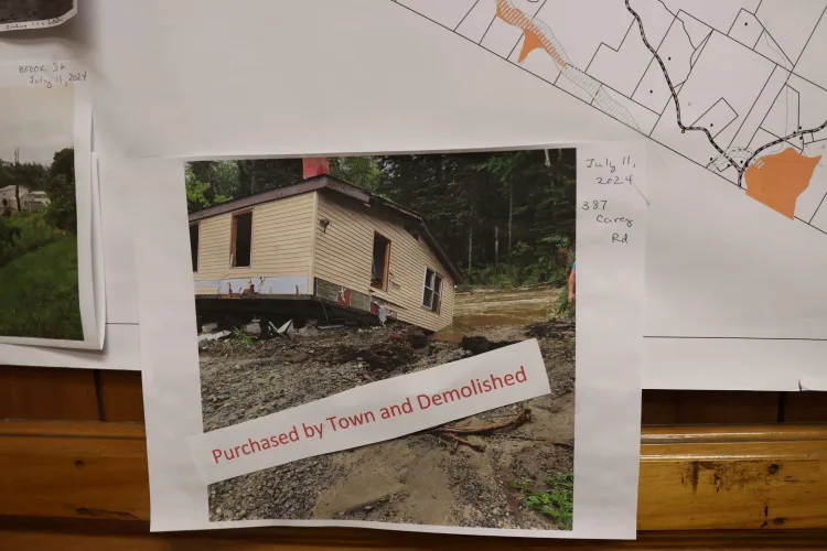 Map with a photograph of a flooded home with text reading "purchased by town and demolished"