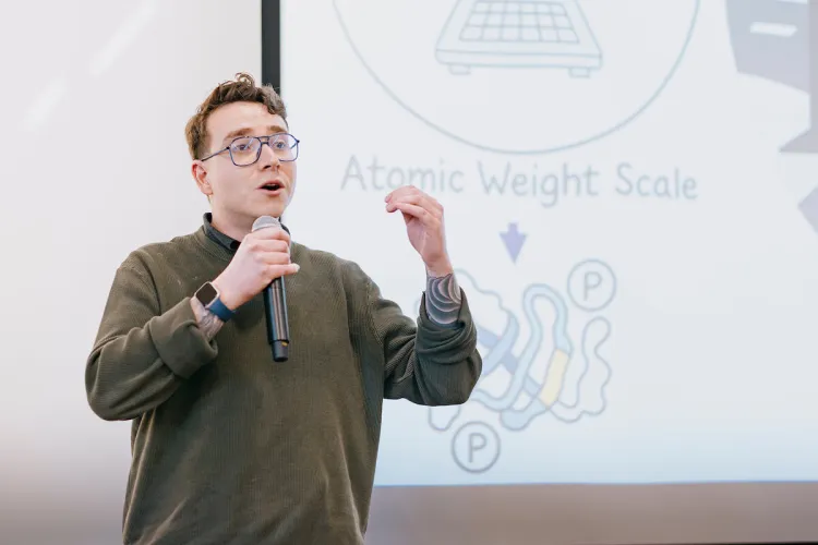 Student giving a presentation with a microphone