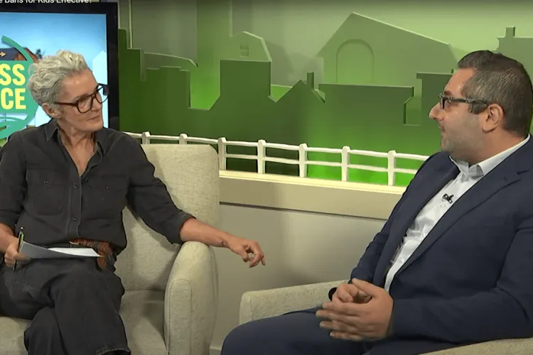 2 people talking on a TV program set