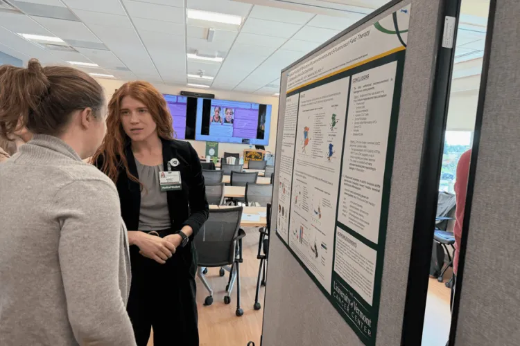 2 people discussing a research poster