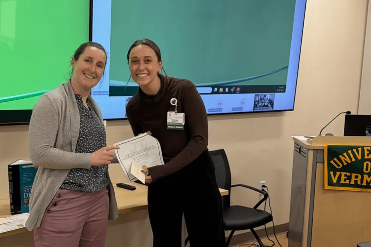 2 people posing with an award