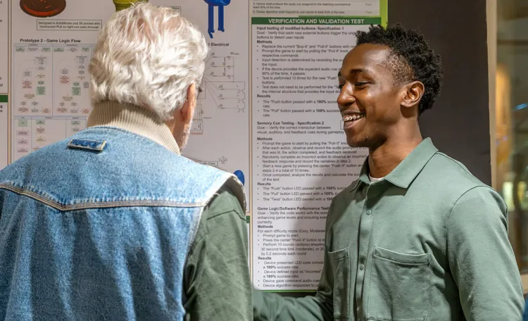 A BME student shares their capstone project with a faculty member