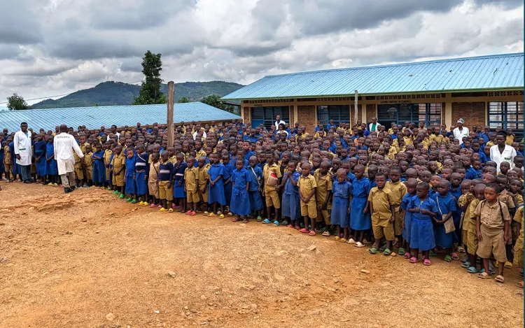School children, aged 5 to 18, gathered outside the only school in Kajinge, Rwanda