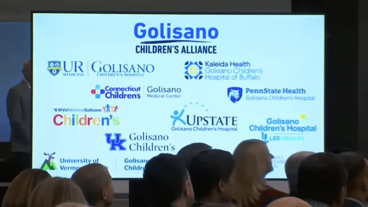 a screen with hospital names and logos at a press conference