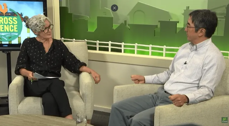 2 people talking on a TV program set