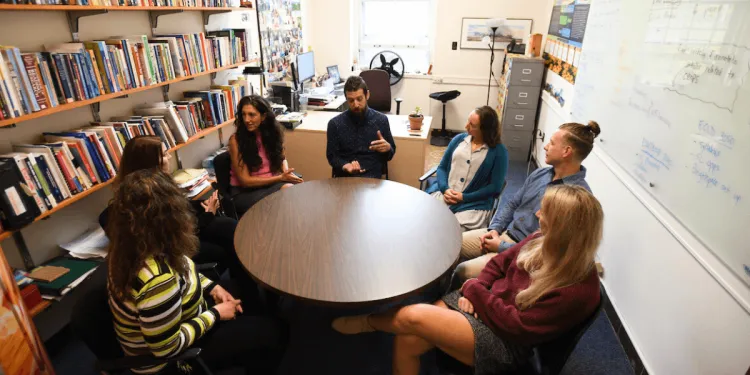 Students collaborate around a table