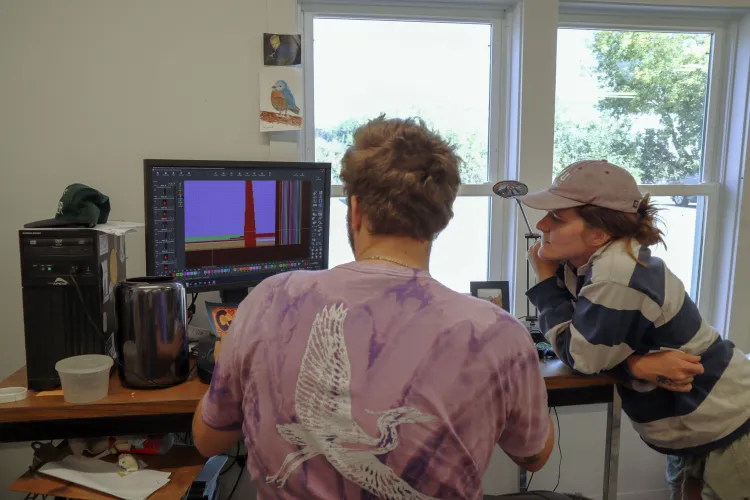 Man showing woman a computer program.