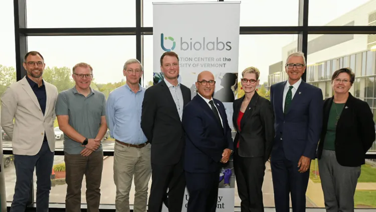 a group of people standing in front of a banner