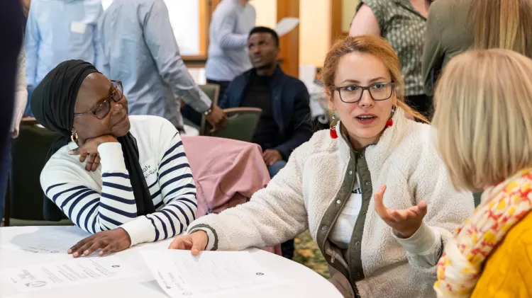 Shiva Soroushnia and Saadatu Abdul-Rahaman chatting at a table