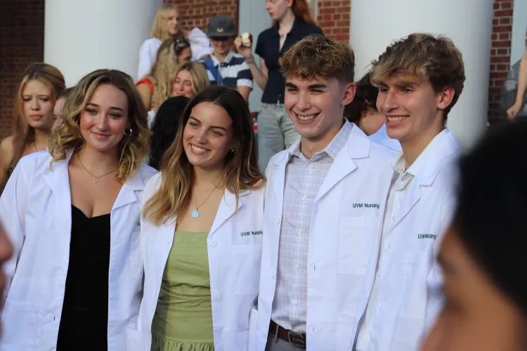 Nursing students in white coats on steps of Ira Allen after White Coat ceremony