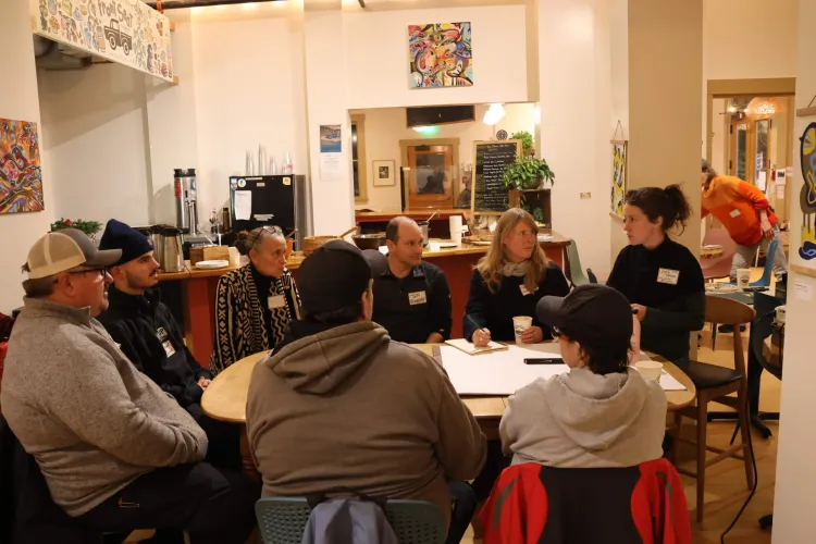 Group of adults talking around a table