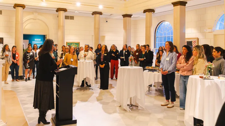 A speaker addresses the audience at the Women in Business mixer at the Fleming Museum