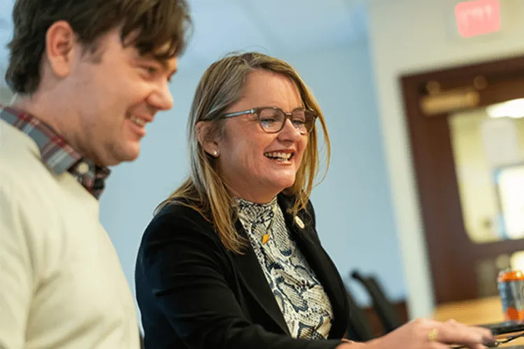 2 people looking at a computer