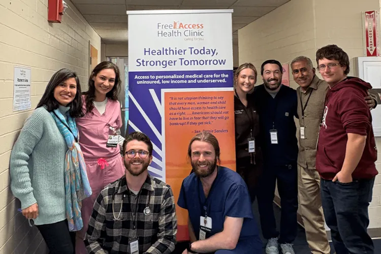 a group of people posing with a banner