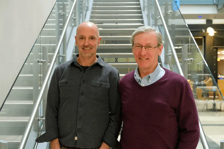 2 people standing near a stairway