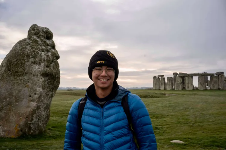Carlos standing in front of Stonehenge
