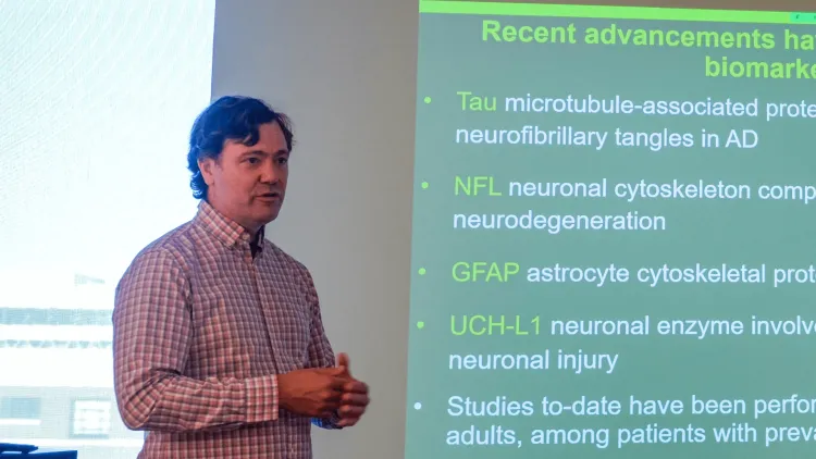 a person presenting in front of a big screen