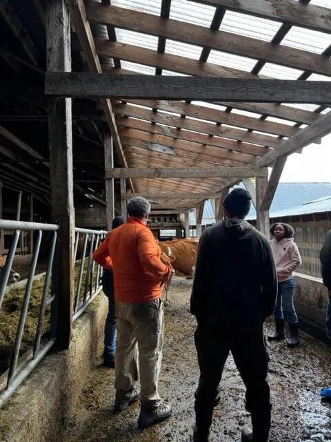 a group of people in a dairy barn