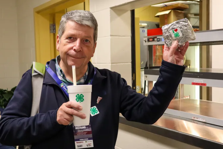 Man holding shake and grilled cheese.
