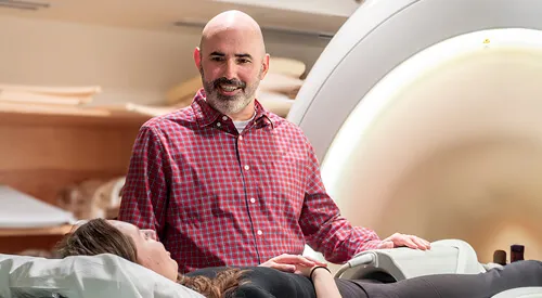 man talking to patient in an MRI machine